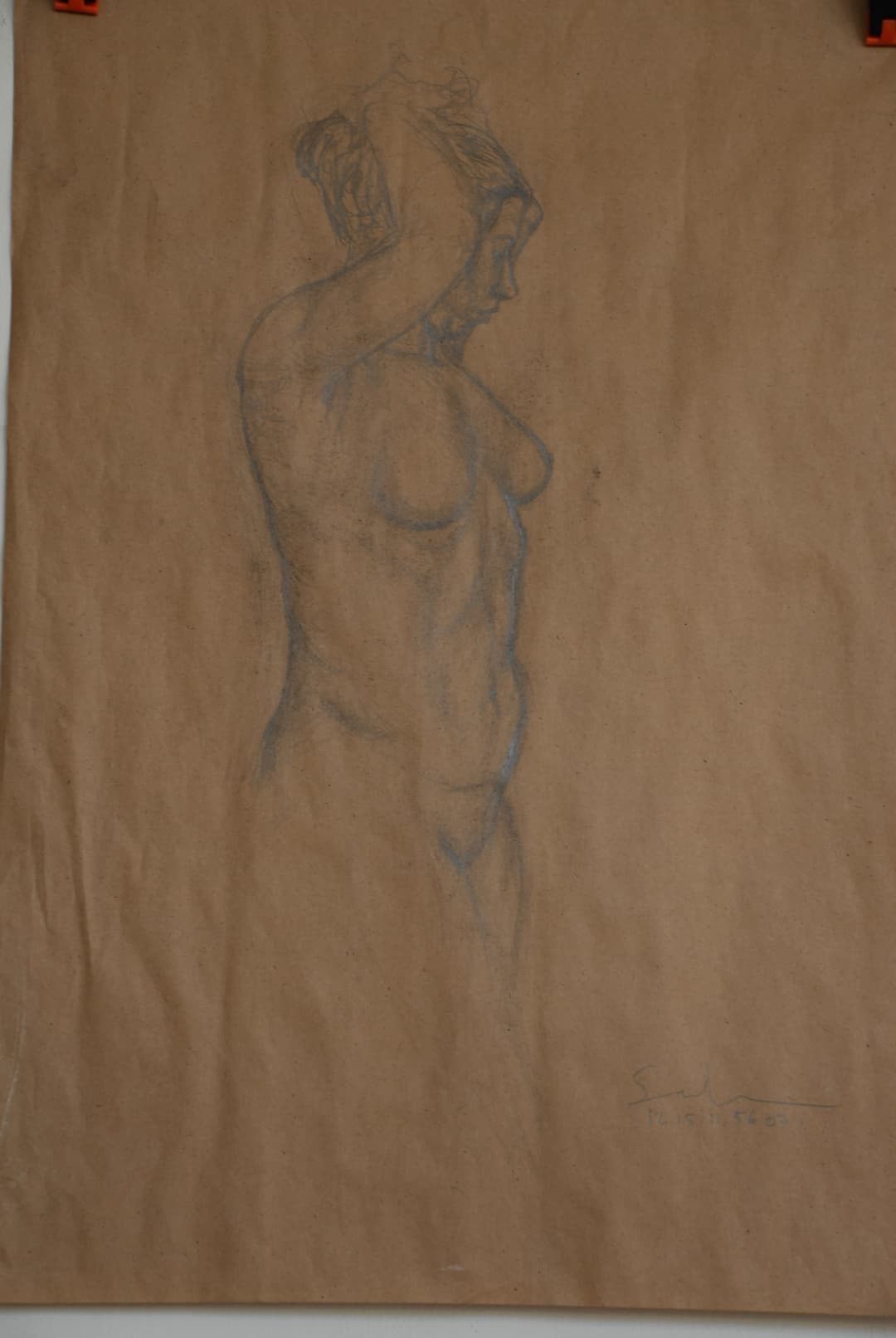 A pencil sketch of a seated woman in profile, wearing a flowing dress.